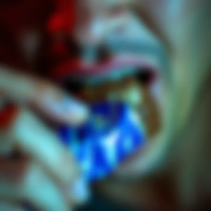 A person taking a bite of a Snickers bar, showcasing the chocolate, caramel, and nuts inside the candy.