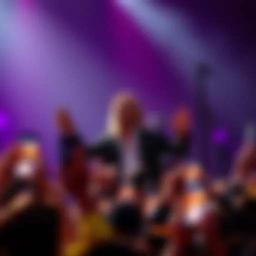 Jared Leto performing on stage with a crowd in front of him, holding up their phones
