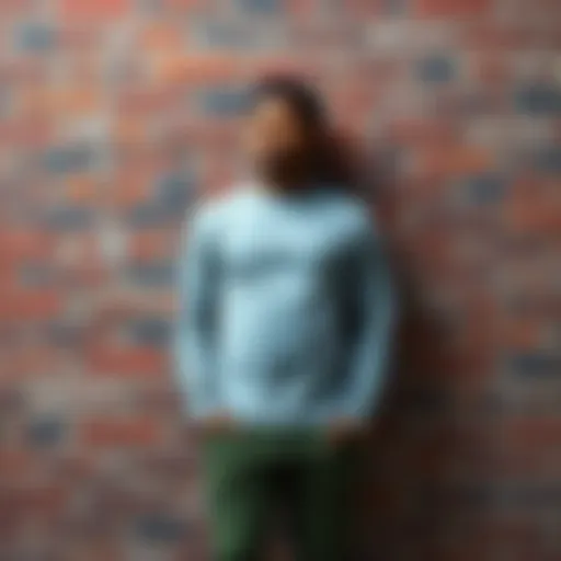 An individual dressed in gray, leaning against a reddish brick wall, representing their unique identity claim as a wall.